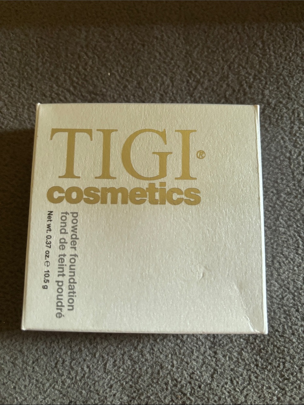 TIGI cosmetics powder foundation - white and gold packaging